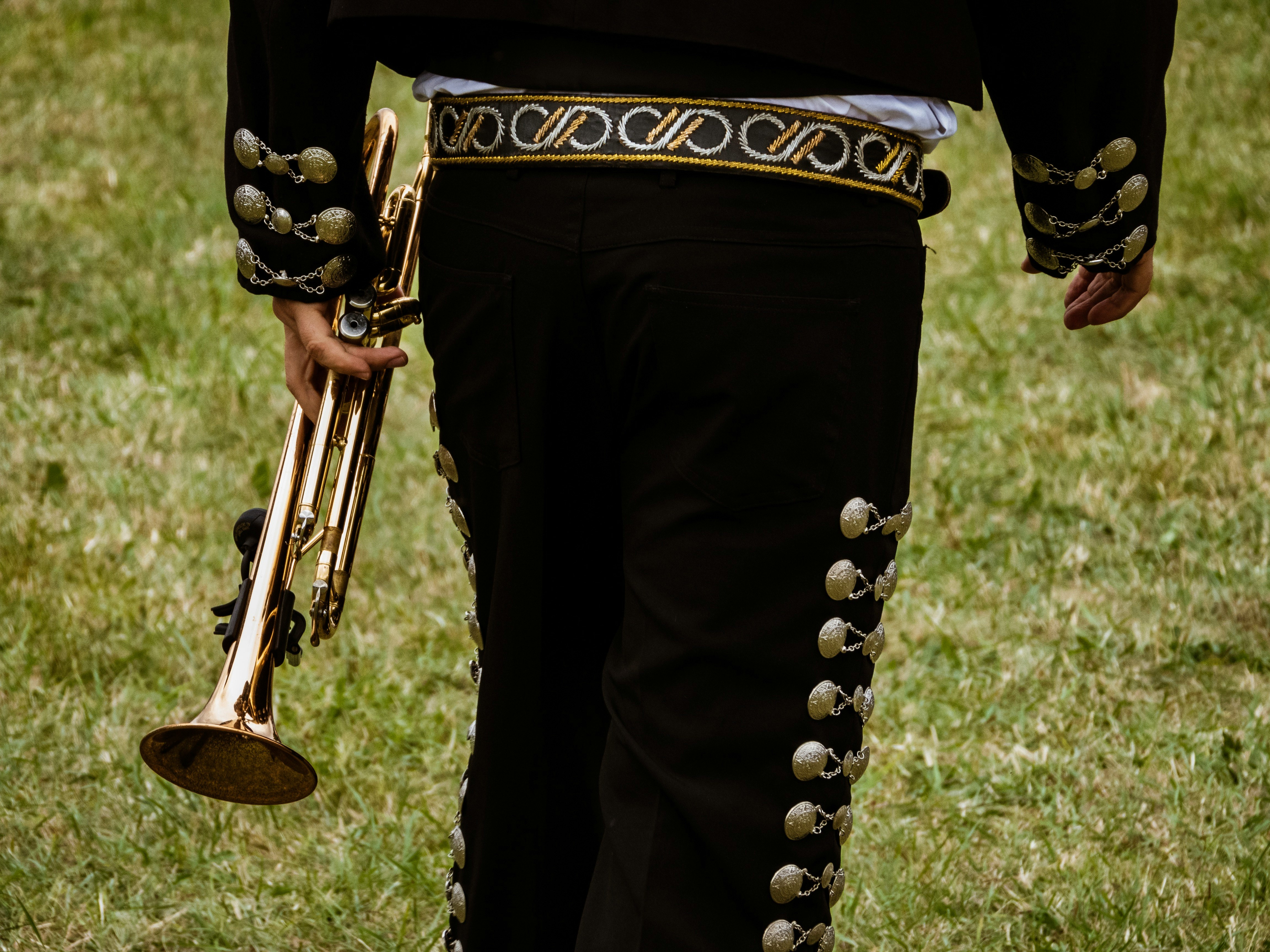 close-up photography of person holding trombone